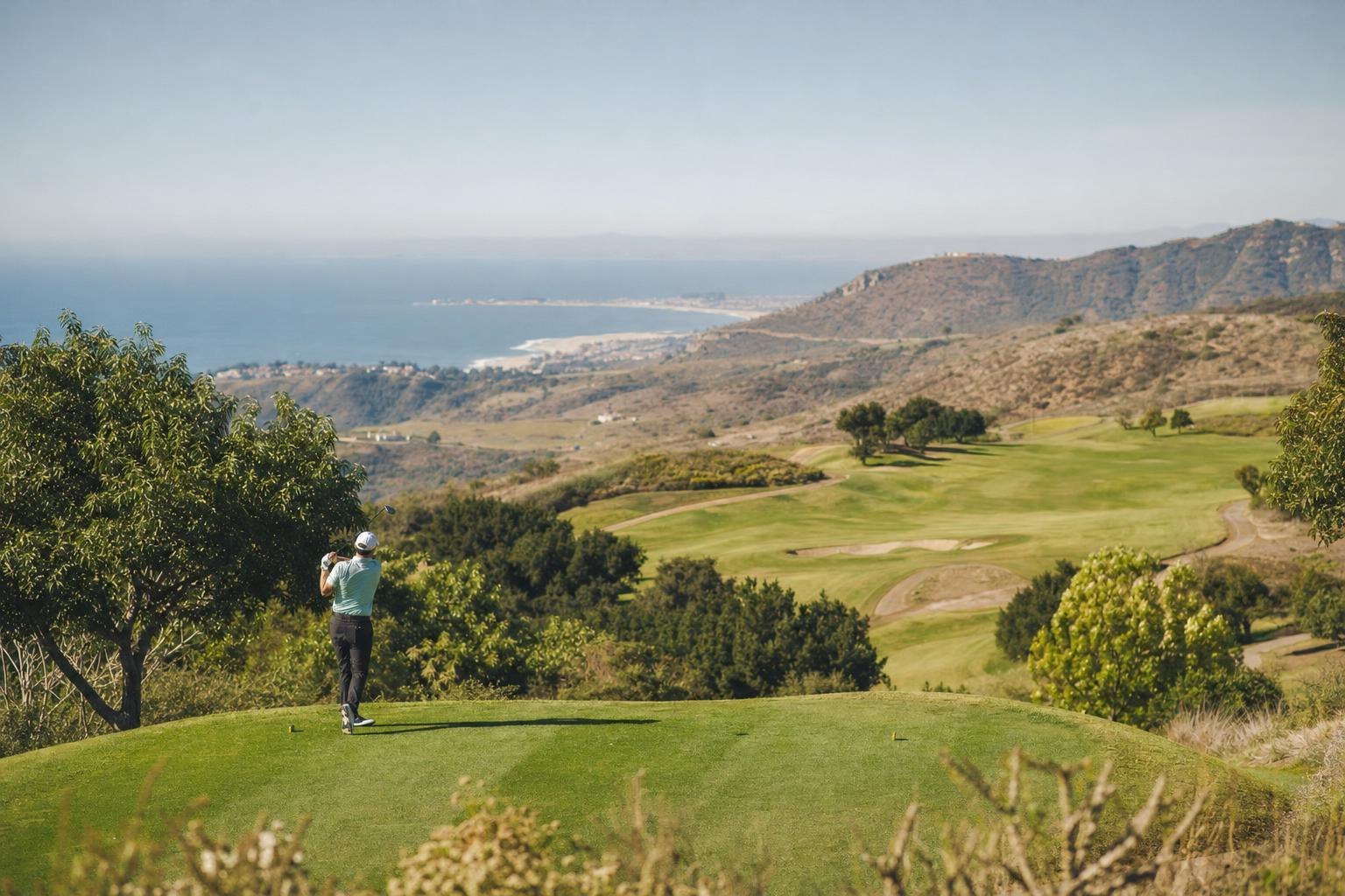 A foothill golf course with ocean views far below, avocado trees and hills (AI-generated image)