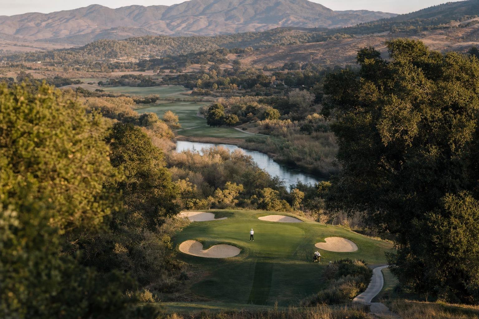 Elevated view over several golf holes winding through oak groves and a river corridor, valley setting (AI-generated image)